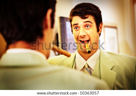 Business man talking himself up in the mirror. Whos the best? You\'re the best. Thats right.