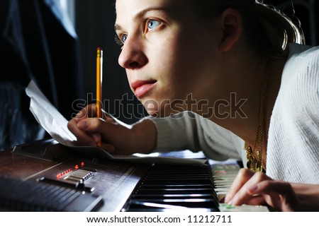 A young woman writing music.