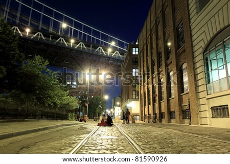 Photo session on a street under the  Manhattan Bridge in Brooklyn NYC at night
