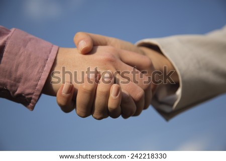 Close-up image of business people shaking their hands