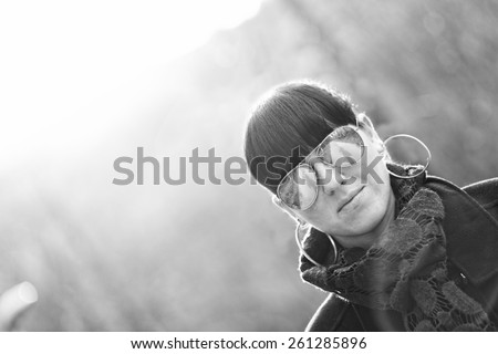 Unusual angle portrait of model wearing shades in black and white