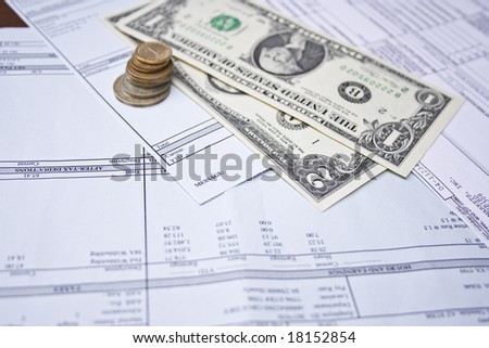 pay checks, coins and US dollars