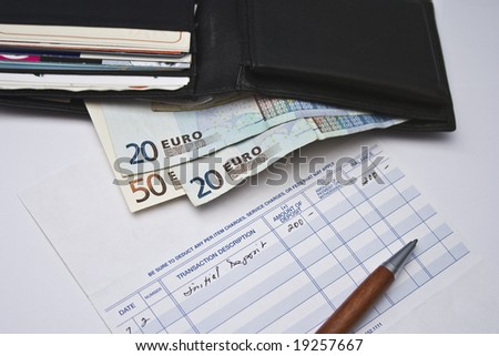 wallet with money, pay check and pen