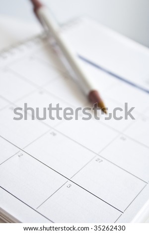 Pen over calendar sheet  Focus on the sheet