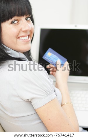 Beautiful lady using online banking at home