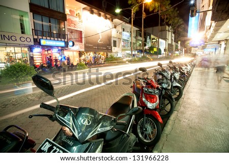 BALI - DECEMBER 27: Nighttime, mopeds stays in the parking, Kuta\'s area on December 27, 2012 in Bali, Indonesia. Kuta is known internationally for its long sandy beach, many restaurants and bars.