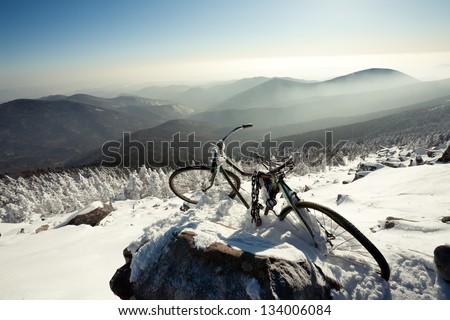 Winter landscape of mountains. old bicycle on a mountain top. Russia, Pidan