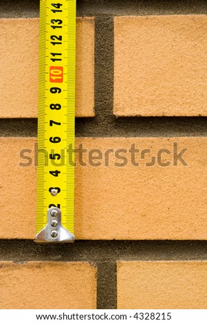 Measuring ruler on a background of a brick wall