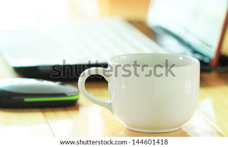 coffee with white notebook on wooden desk background