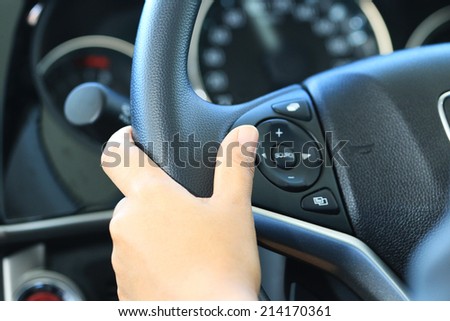 Business woman push a button in modern car.