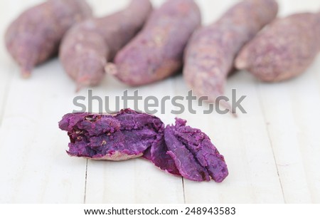 Purple Sweet Potato on wood background.