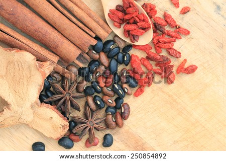 Nuts and chinese herb on wood background.