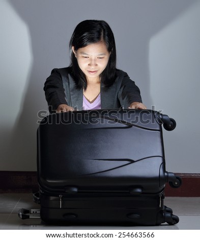Woman open luggage with something light, Positive face expression, emotion, anticipation