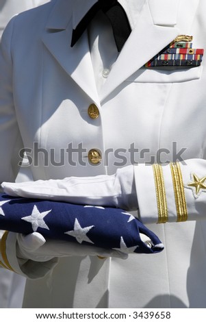 Female Naval Officer with Folded American Flag During Ceremony