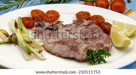 Pork chop with onions and tomatoes