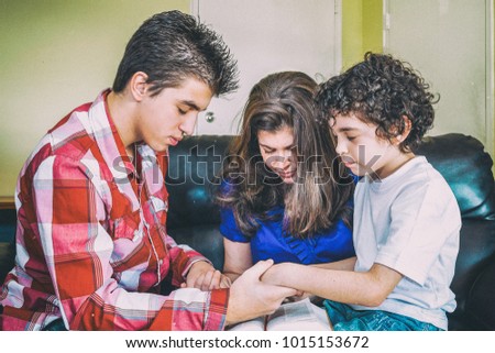 Christian family pray in their daily devotional at home