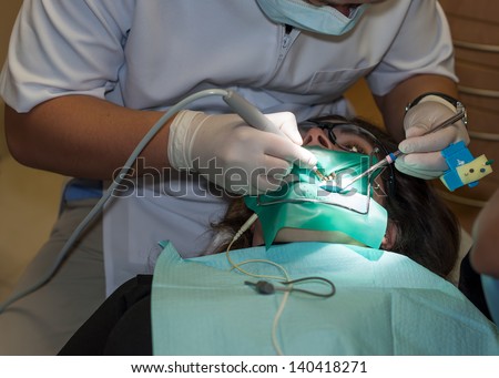 Woman receiving a root canal at the dentist