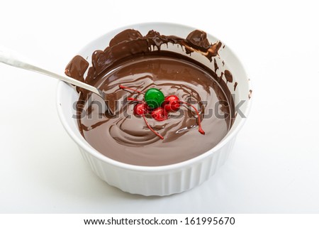 Chocolate & Cherries.Close up of melted chocolate in a white pot. Delicious and popular sweet staple. Texture and highlights in one of the most popular sweet food.