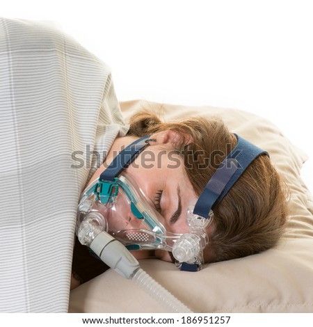 Hispanic middle age woman suffering form sleep apnea. Wearing cpap mask to relieve her condition or disorder