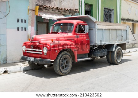 SANTA CLARA, CUBA-JUNE 28, 2014: Old truck used for construction work. After the government economic reforms, citizens are improving their housing conditions with more ease and legal peace of mind.