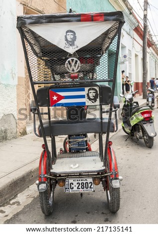 SANTA CLARA, CUBA - JUNE 28,2014: Cuban bici taxi waiting to get passengers. After the economic changes in Cuba, many are resorting to self employment.