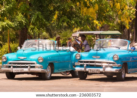 HAVANA,CUBA-JULY 17,2014: Old American cars running and making income for its owners. Due to scarcity in cars supply, Cubans have been forced to innovate and invent to keep these oldtimers running