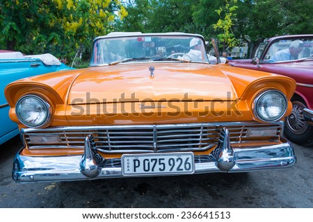 HAVANA,CUBA-JULY 12,2014: Old American cars for rent in central Havana. Due to scarcity,Cubans have kept old cars from 1950s running and nowadays is one important source of income