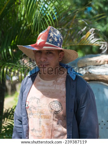 TRINIDAD,CUBA-JULY 23,2014: Cuban man wearing a hat with half the Cuban flag and the other half the US flag. Recently, both countries decided to start diplomatic relations after 50 years.