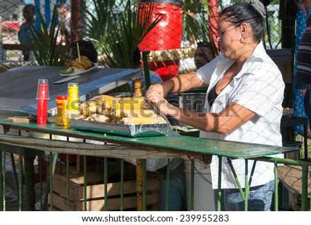 SANTA CLARA,CUBA-JULY 26,2014: Street sellers of food during the popular festivities or carnivals. On this date, Cubans celebrate the assault to the Moncada barracks by Fidel in 1953.