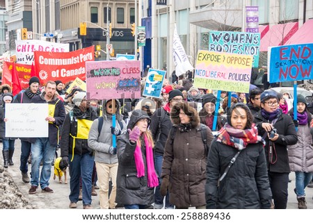 TORONTO,CANADA-MARCH 8,2015: Thousands gathered in Toronto to mark International Women Day IWD with a protest march demanding improvements in many social issues.