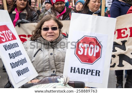 TORONTO,CANADA-MARCH 8,2015: Thousands gathered in Toronto to mark International Women Day IWD with a protest march demanding improvements in many social issues.