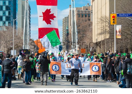 TORONTO,CANADA-MARCH 15,2015:Irish flag along with Canadian flag during the St. Patrick\'s Day Parade 28th edition which is the fourth largest celebration of its kind in the world.