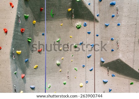 Indoor rock climbing wall in a sport facility where many practice to be fit and in better health