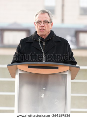 TORONTO,CANADA-JANUARY 11,2015: Joe Oliver, Minister of Finance in Canada addresses the people in a vigil at Nathan Phillips Square to honor the victims of the Charlie Hebdo magazine shootings