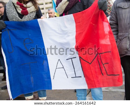 TORONTO,CANADA-JANUARY 11,2015:People meet  in the Je Suis Charlie vigil at Nathan Phillips Square to honor the victims of the Charlie Hebdo magazine shootings and to demonstrate against the terrorism