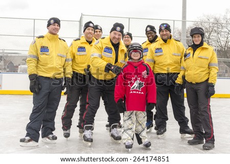TORONTO,CANADA-JANUARY 3,2015: Toronto Police members partake in the official opening of the Regent Park ice rink; they served the community helping children in learning skating skills