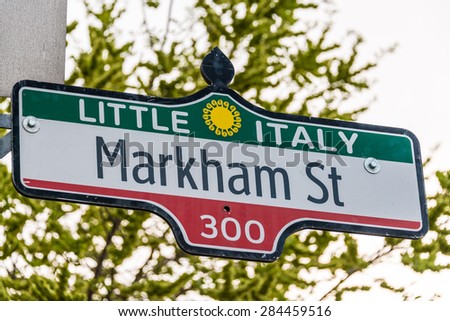 Little Italy, Green, white, red Markham St. sign. Little Italy is a general name for an ethnic enclave populated primarily by Italians usually in an urban neighborhood.