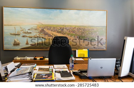 TORONTO,CANADA-MAY 24,2015: Inside the Toronto Mayor\'s Office during John Tory government, the working desk with publications and electronic devices.