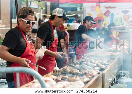 TORONTO,ONTARIO-JULY 5,2015: Charcoal cooking chicken in street food stand in  St. Clair Ave West is the largest Hispanic festival in Canada gathering thousands every year.