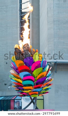 TORONTO,CANADA-JULY 18,2015: Toronto Pan American games 2015: Scenes of the Pan Am flame burning by the CN Tower in downtown. The Panam flame is set on an acorn with different colors
