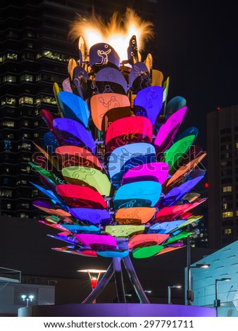 TORONTO,CANADA-JULY 18,2015: Toronto Pan American games 2015: Scenes of the Pan Am flame burning by the CN Tower in downtown. The Panam flame is set on an acorn with different colors