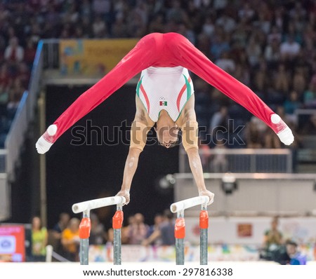 TORONTO,CANADA-JULY 15,2015: Daniel Corral Barron performs in the parallel bars during the final of the gymnastic artistic competition of the Toronto Pan American Games  2015