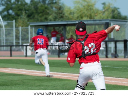TORONTO,CANADA-JULY 12,2015: Toronto Pan American Games 2015, Baseball tournament: Canadian catcher Kelly Deglan throws to first base and puts out Sneider Batista from Colombian
