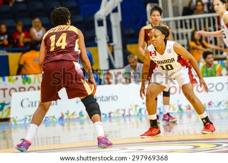 TORONTO,CANADA-JULY 16,2015: Toronto 2015 Pan Am or Pan American Games, women basketball: Nirra Fields (10) defends the Canadian court trying to stop the attack progress from opponent team.CN 01953074