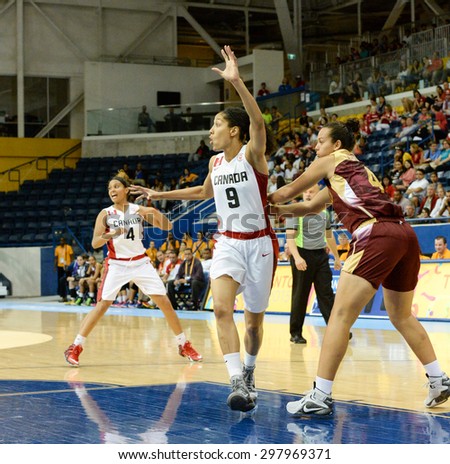 TORONTO,CANADA-JULY 16,2015: Toronto 2015 Pan Am or Pan American Games, women basketball: Miranda Ayin (9) from team Canada enters the attack area swiftly asking for the ball to score.CN 01953074