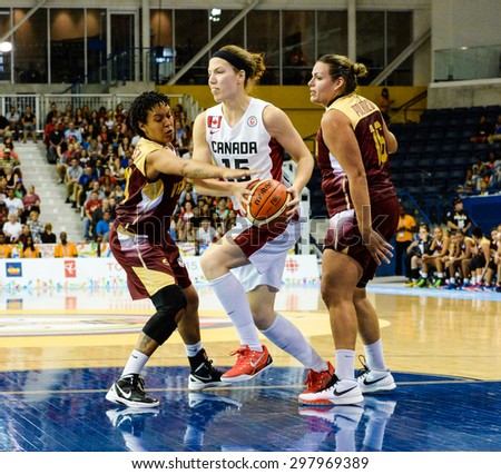 TORONTO,CANADA-JULY 16,2015: Toronto 2015 Pan Am or Pan American Games, women basketball: Michelle Plouffe (15) from team Canada enters the attack zone with the ball in hands \
CN 01953074
