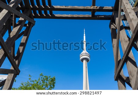 TORONTO,CANADA-JUNE 15,2015: View of the CN Tower through the Chinese Railway Workers Memorial. The CN Tower is a 553.33 meter high concrete communications and observation tower