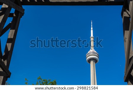 TORONTO,CANADA-JUNE 15,2015:  View of the CN Tower through the Chinese Railway Workers Memorial.The CN Tower is a 553.33 meter high concrete communications and observation tower.
