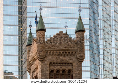 Contrasting Toronto Architecture: Vintage architecture buildings at the University of Toronto.  The building looks similar to a castle, made of brown stone with green on top of the towers.