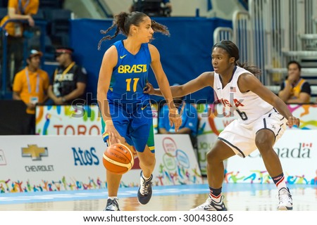 TORONTO,CANADA-JULY 20,2015: Toronto 2015 Pan Am or Pan American Games, women basketball: Brazil number 11 Carina Martins attack the US area defended by Linnae Harper (6)